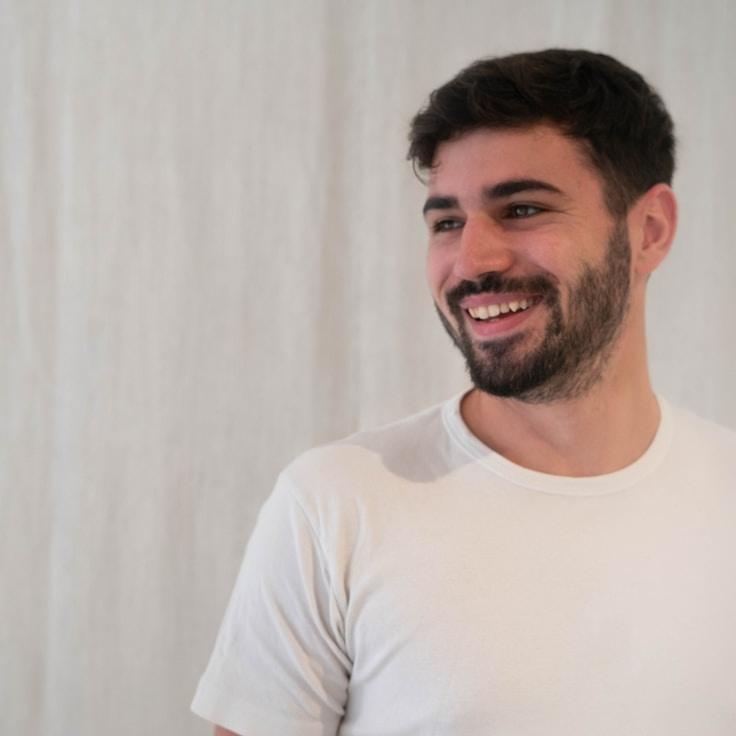 Alex Chen, Lead Design Curator at RiverLodgeCalm, reviewing corporate floral arrangements